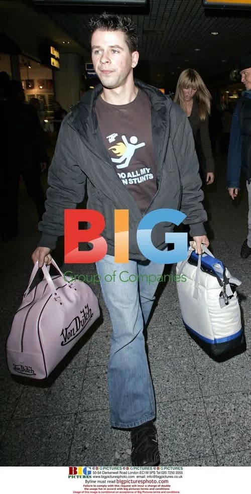 Heather Mills Arrives at Heathrow with Folder