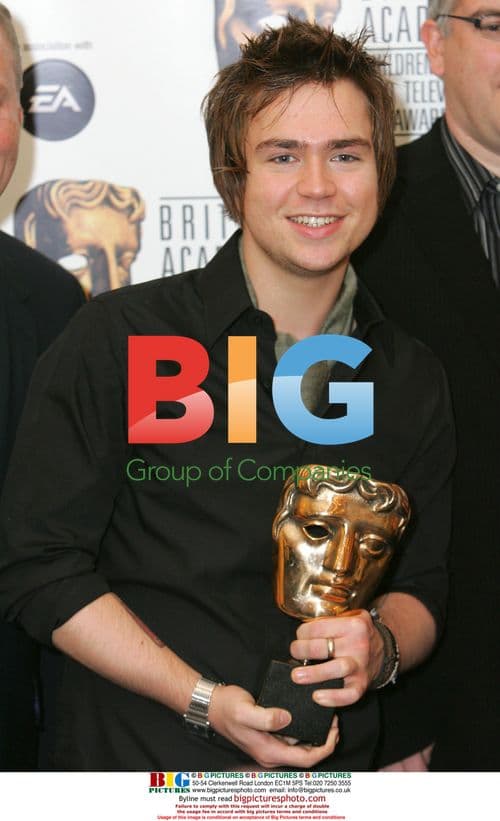 Sam Nixon poses with award