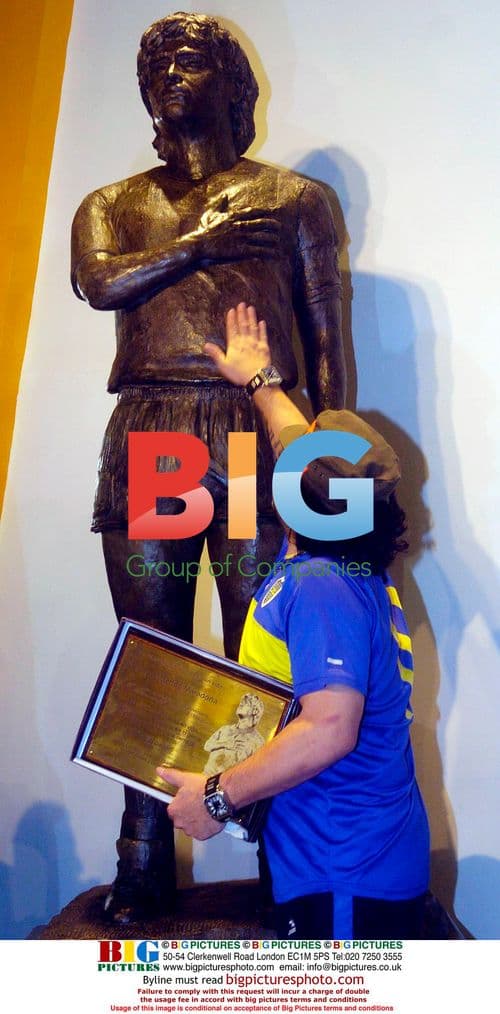 Diego Maradona Poses With Statue