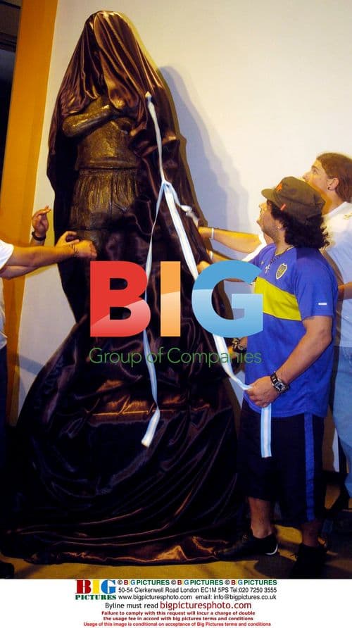 Diego Maradona Poses With Statue