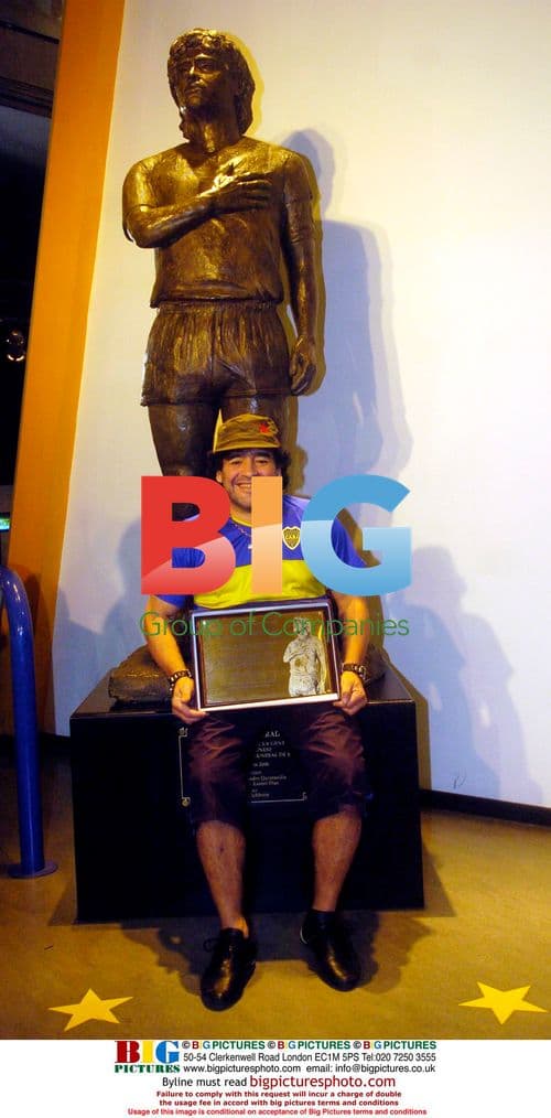 Diego Maradona Poses Next to Statue