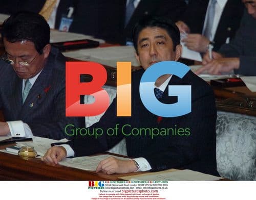 Shinzo Abe listens to Yukio Hatoyama in parliament