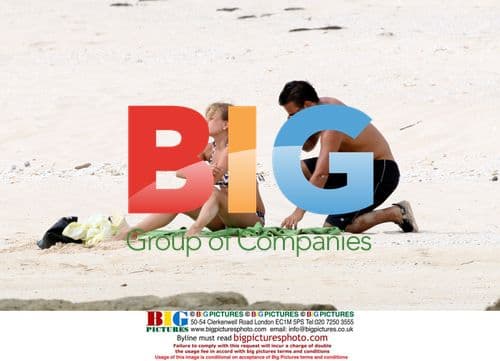 Tina O'Brien and Ryan Thomas play on Greek beach