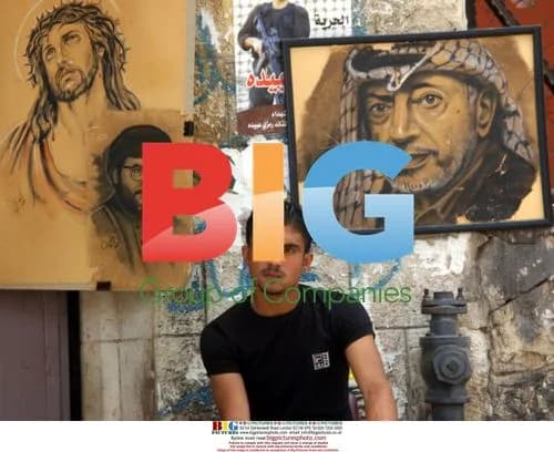 Palestinian in front of drawings