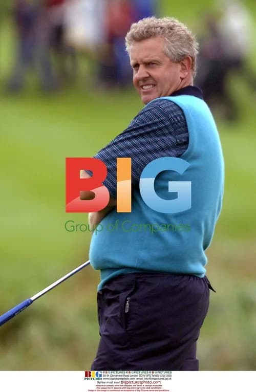Colin Montgomerie watches teammates putt