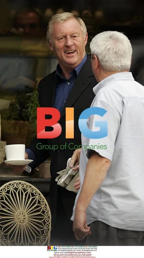 Chris Tarrant chats on phone at cafe