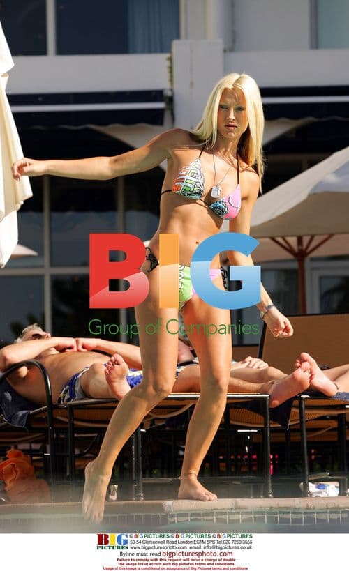 Caprice Relaxes by Hotel Pool in South Africa