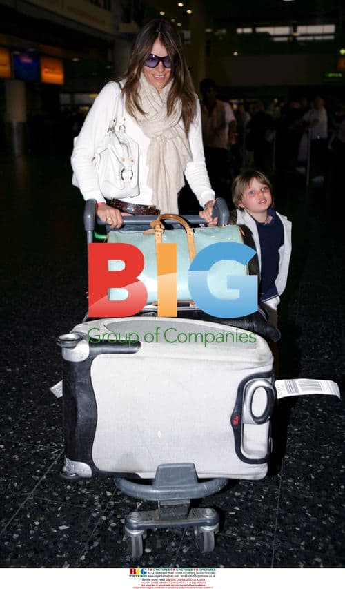 Liz Hurley with son Damien and designer Partrick Cox at Heathrow