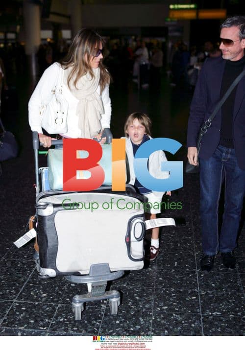 Liz Hurley Arrives at Heathrow with Son and Designer