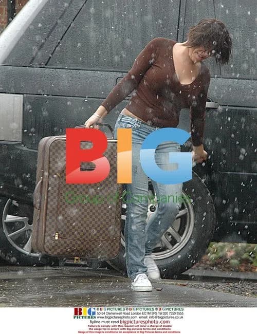 Jade Goody Struggles with Bag in Snow