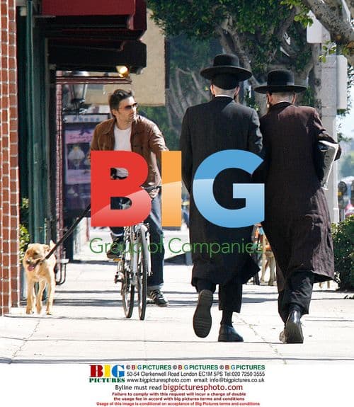 Olivier Martinez riding bike with dog