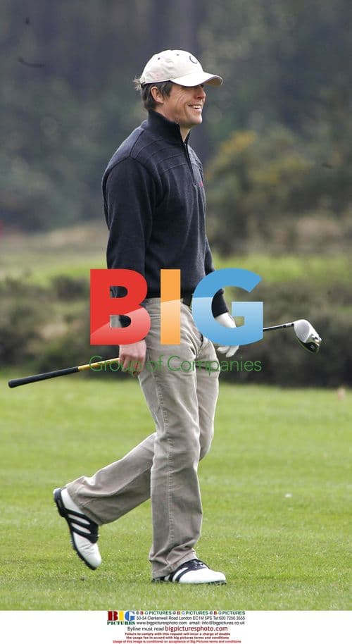 Actor Hugh Grant playing golf