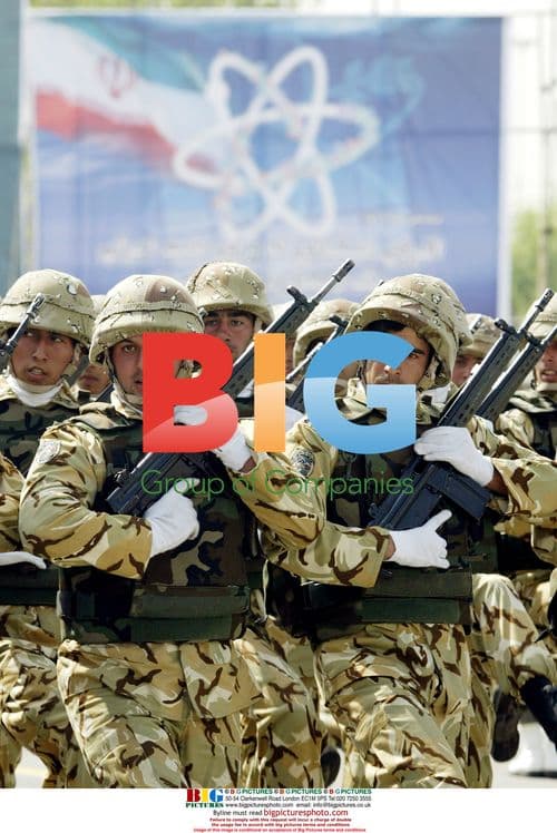 Iranian Army soldiers march under nuclear sign