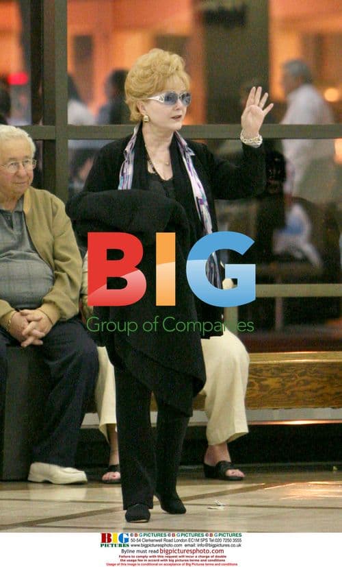 Debbie Reynolds arrives at LAX with wheelchair