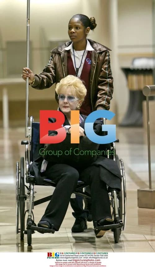 Debbie Reynolds Arrives at LAX in Wheelchair