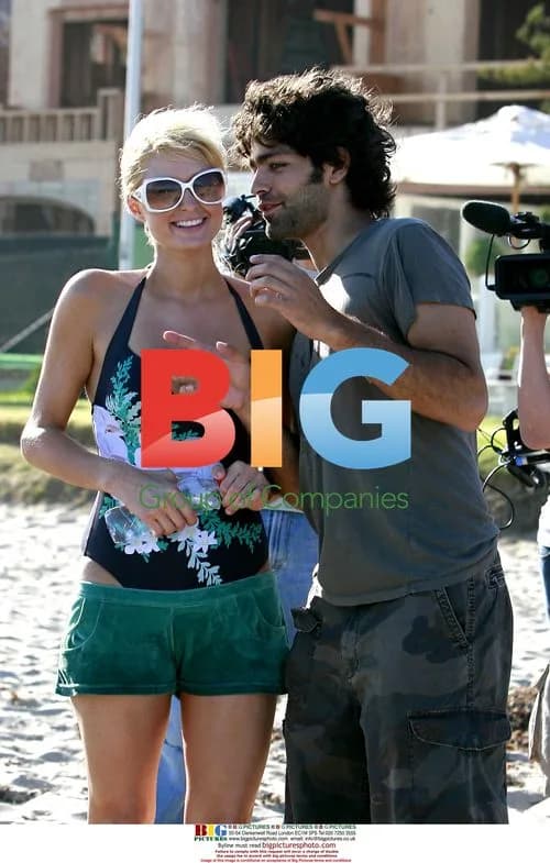 Paris Hilton and Adrian Grenier frolick in the Malibu waves