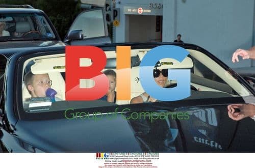 Victoria Beckham leaves office with sons