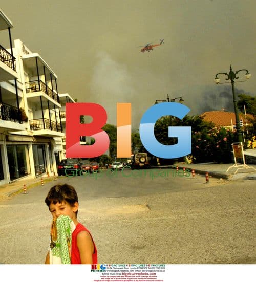 Boy watches Greece fires in Olympia