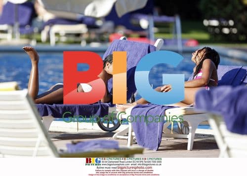 Charley Uchea Relaxes Poolside in Caribbean