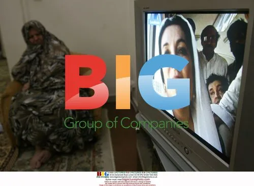 Iranian woman watches TV as Bhutto images shown
