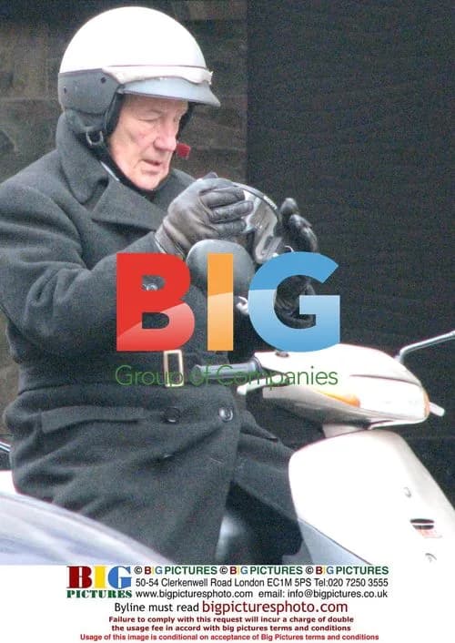 Stirling Moss Starting Scooter Outside Bank