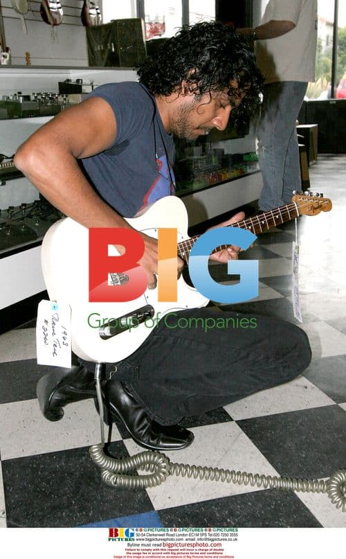 Naveen Andrews Buys Guitar in Hollywood