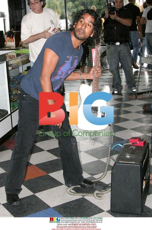 Naveen Andrews Buys Guitar in Hollywood