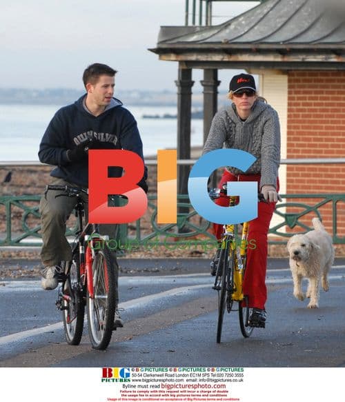 Heather Mills and Trainer Ben Amigoni Cycle With Dog