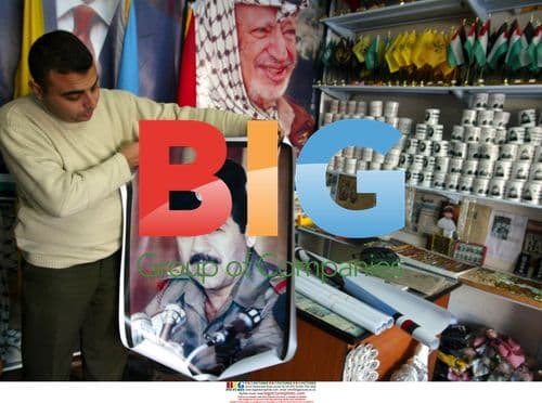 Palestinian Shopkeeper Displays Saddam and Arafat Posters