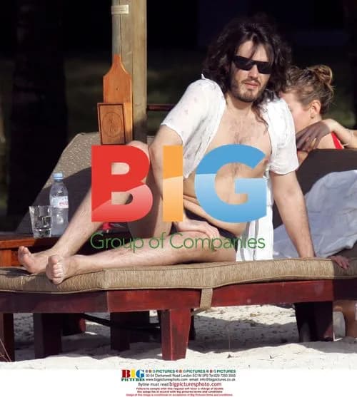Russell Brand and mystery lady on beach