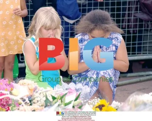 Young girls pray at Diana tributes