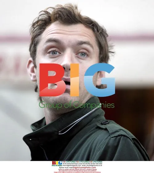 Jude Law Chats with Pals and Steals a Kiss in London