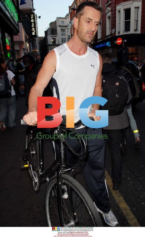 Rupert Everett walking through Soho