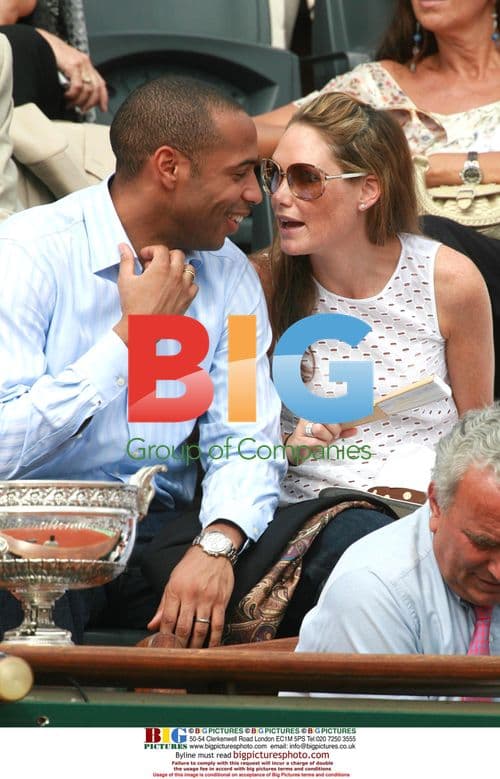 Thierry Henry and partner watch Rafael Nadal defeat Roger Federer