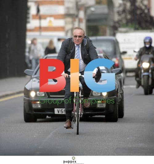 Andrew Neil riding bike without helmet in London