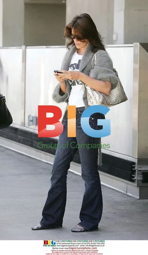 Cindy Crawford waits with cell phone at LAX