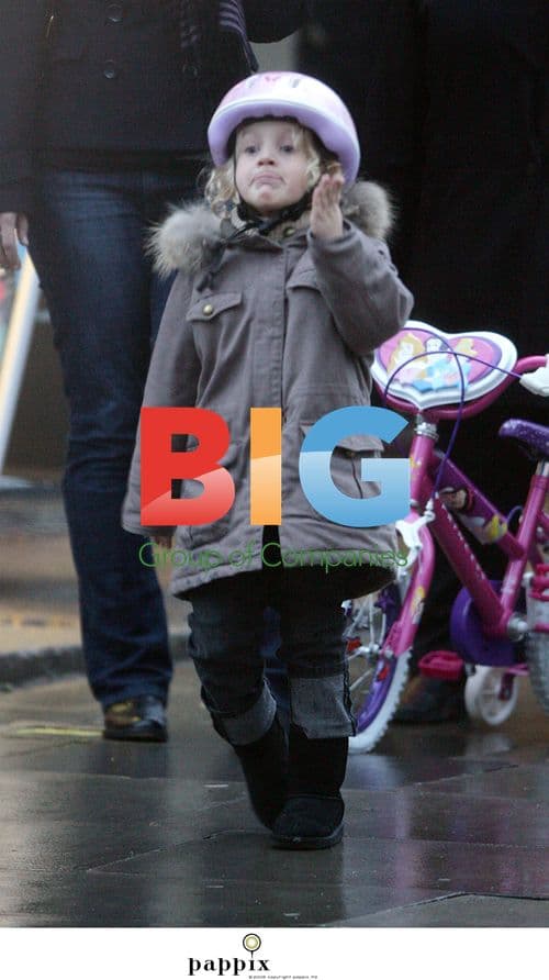 Misty Kyd rides bike in London rain