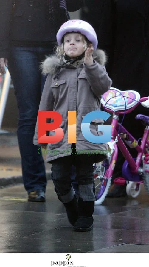 Misty Kyd rides bike in London rain