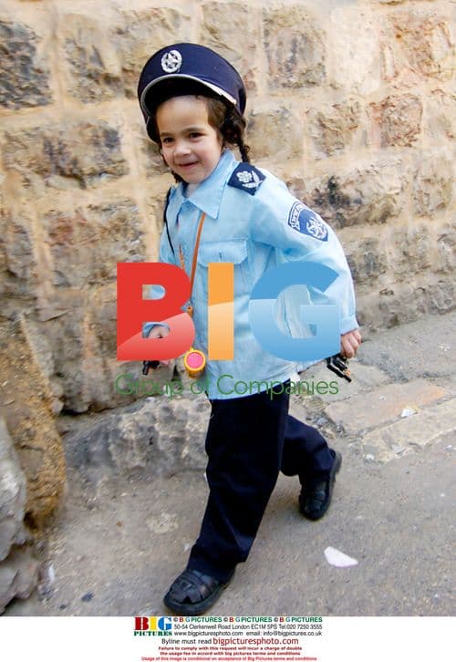 Boy in police costume celebrating Purim