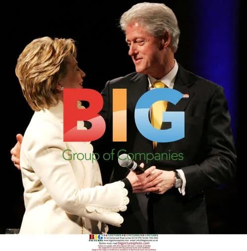 Bill Clinton hugs Hillary Clinton at campaign fundraiser