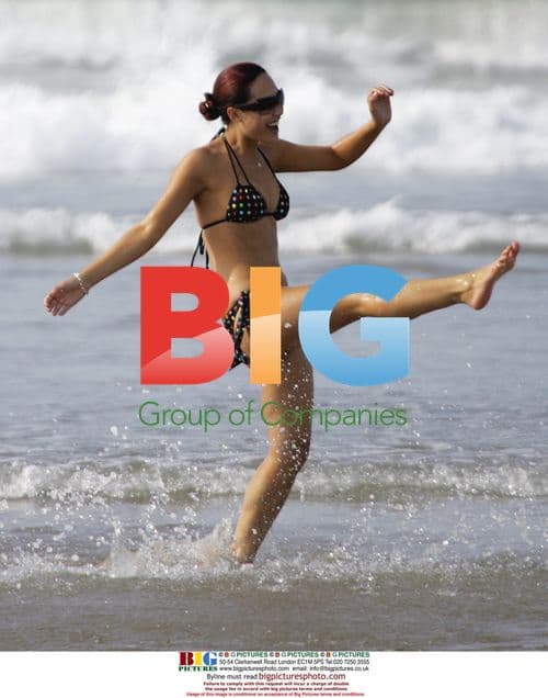 Myleene Klass and friend relax on beach in Spain