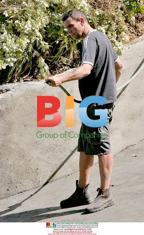 Vinnie Jones waters plants at LA home