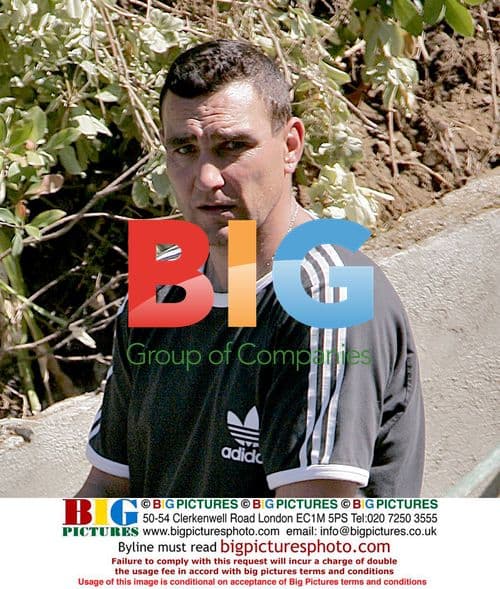 Vinnie Jones waters plants at LA home