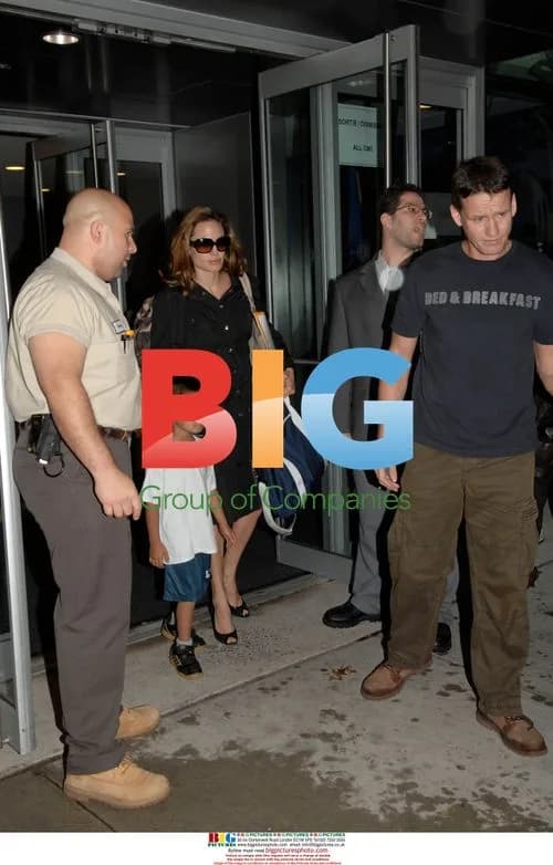 Angelina Jolie Picks Up Maddox in Rain