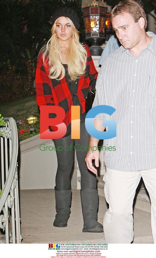 Lindsay Lohan Flanked by Bodyguards