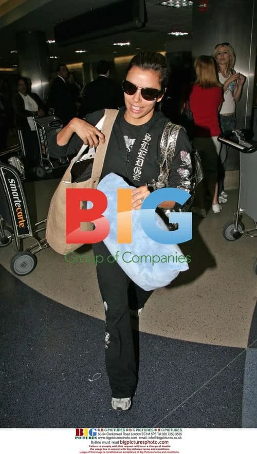 Eva Longoria Arrives at LAX with 'FEED Bag'