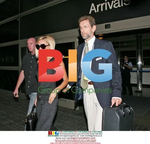 Victoria Beckham arrives at LAX in menswear