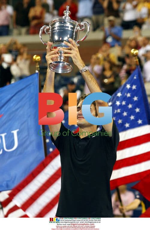 Roger Federer Holds Up U.S. Open Trophy
