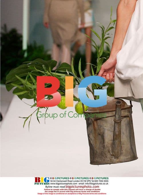 Model in White Floral Dress on Runway