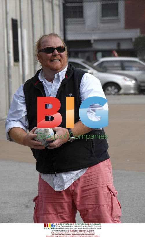Chef Mario Batali plays football with kids
